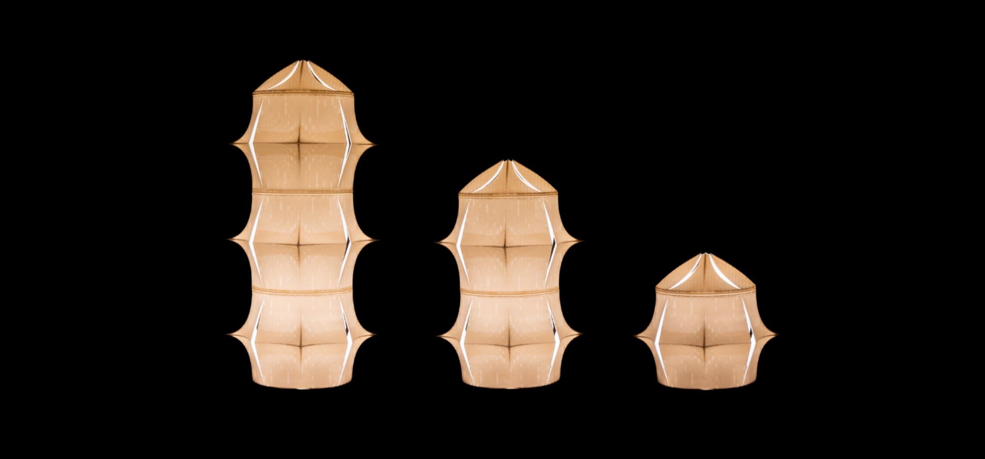 Three Cactea lamps in warm white light — stacks of three, two and one module, showing the modular range